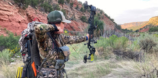 archery woman aiming bow outdoors
