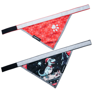 Two dog bandanas with festive designs on a white background. Christmas snowflake design and ugly christmas sweater dino design